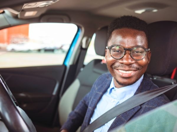 Man Driving a Blue Car