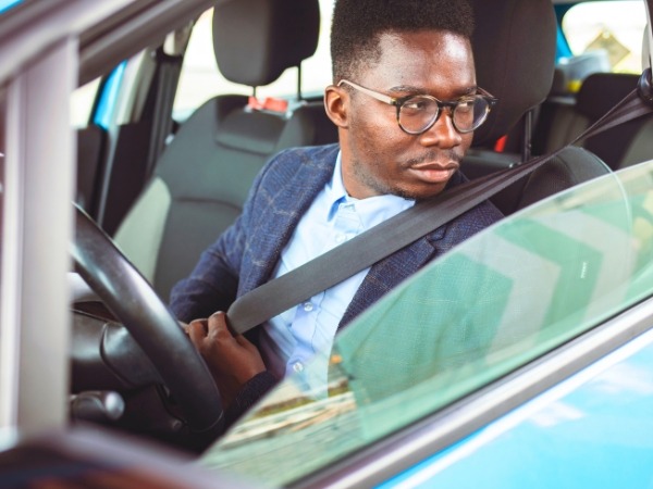 Man Driving a Blue Car
