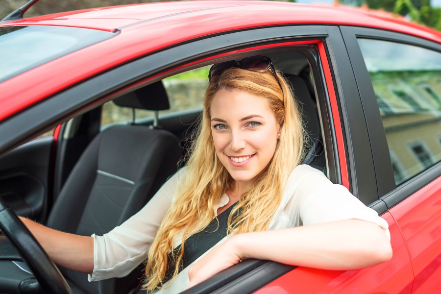 Woman Driving a Red Car