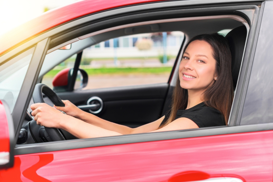 Woman Driving a Red Car