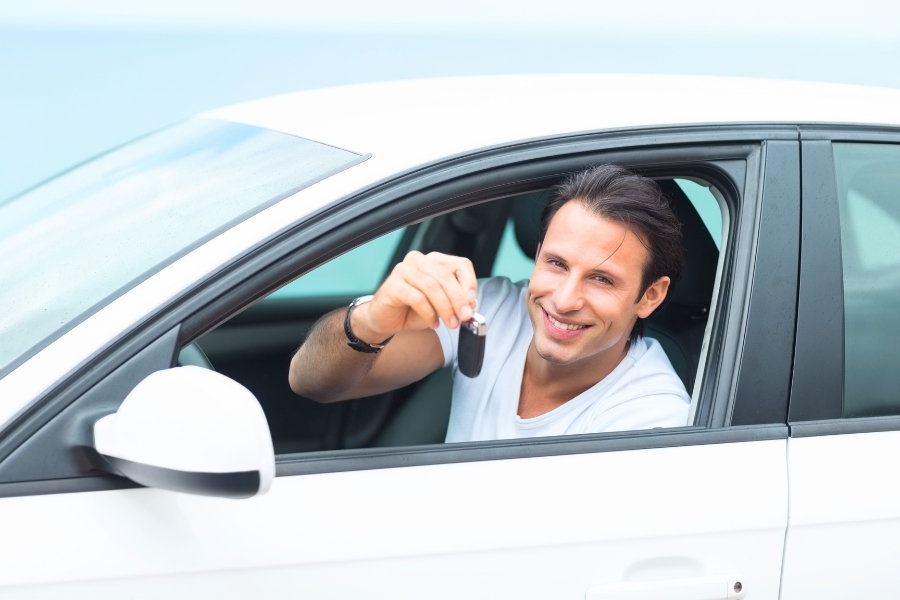 Man Driving a White Car