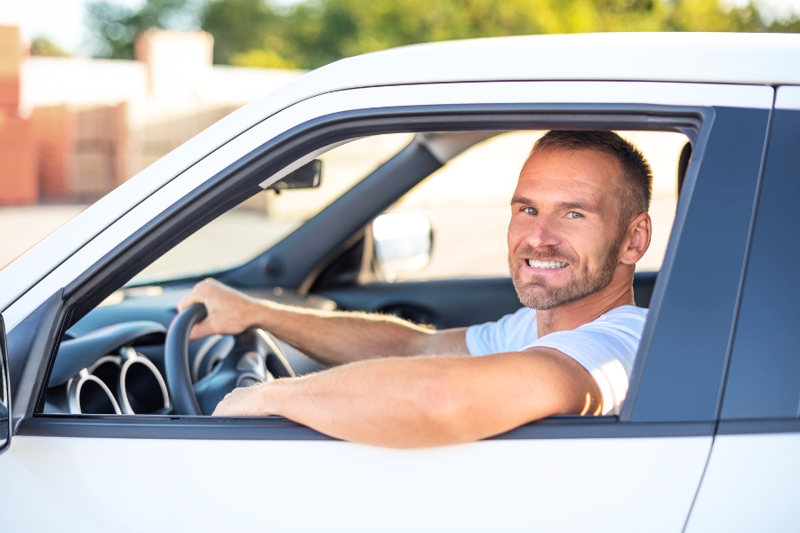 Man Driving a White Car